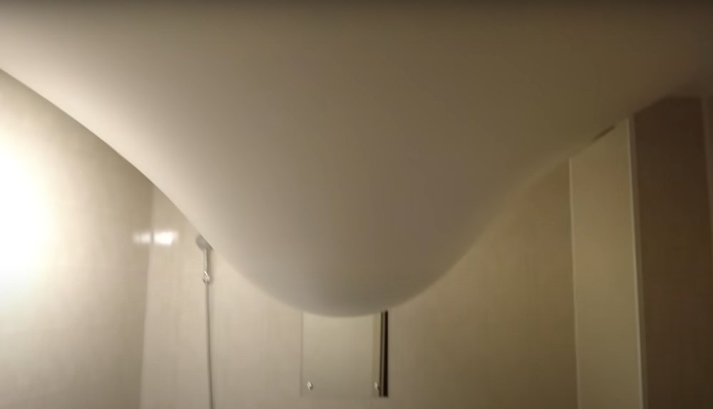 This is how the ceiling looks like in one of the apartments in the Nevsky neighbourhood, which has become a hallmark of the "reconstruction" Mariupol. Water from a cracked pipe in the upstairs apartment flowed into the stretch ceiling of the apartment below, and the ceiling bent to the floor. Screenshot from the YouTube channel "Mirnye"