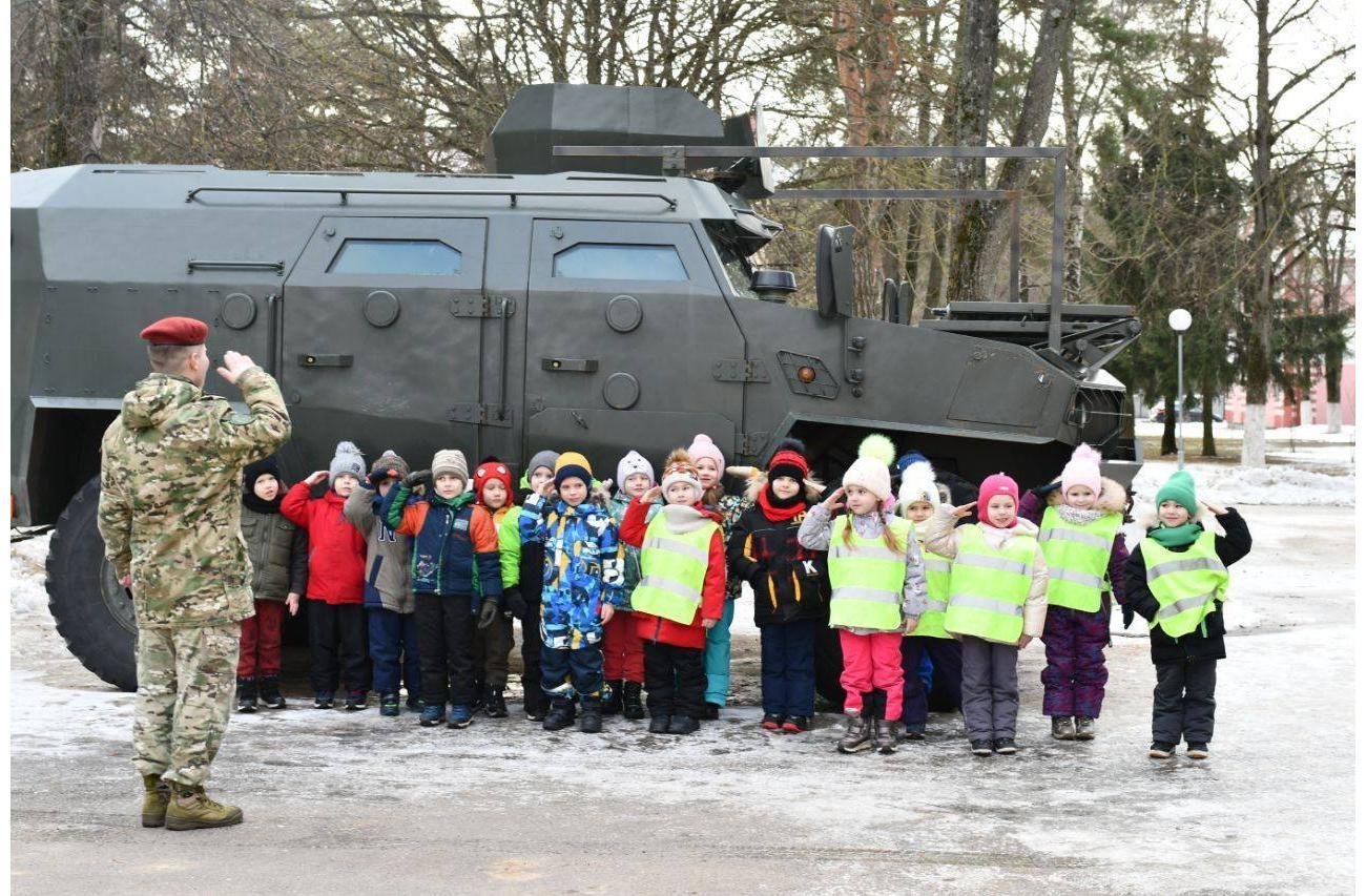 A group from a kindergarten on an excursion to a military unit