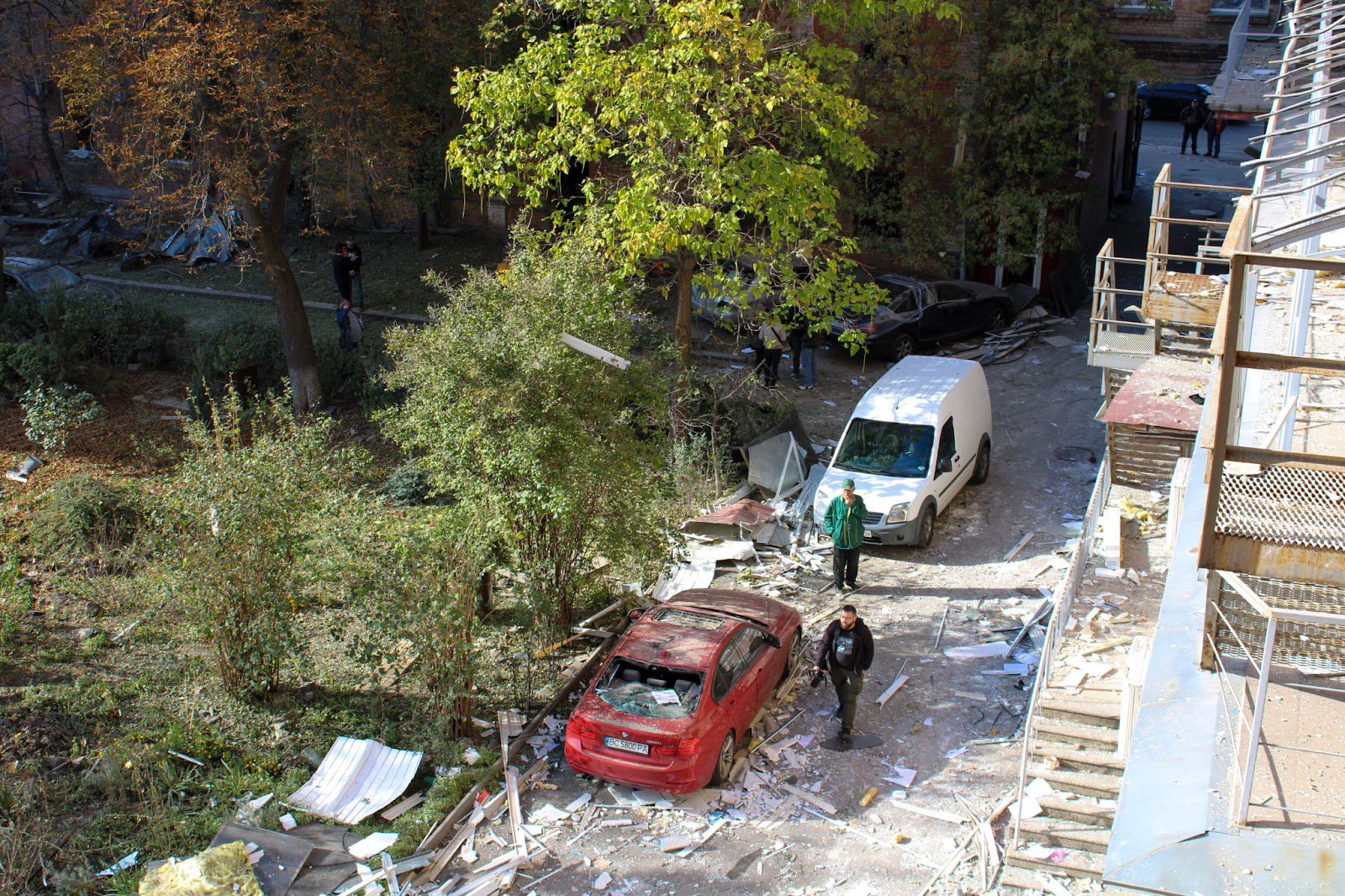 The yard of the house with damaged cars